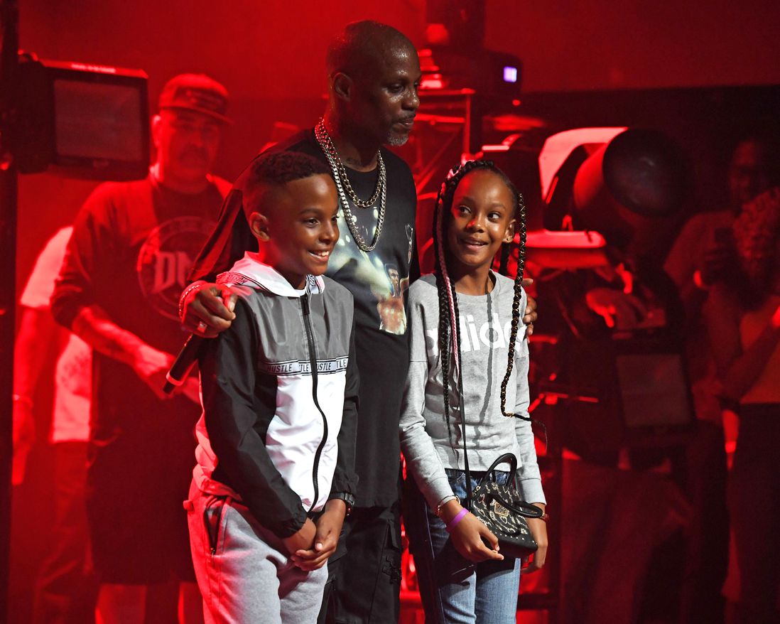 DMX standing with a boy and a girl on stage